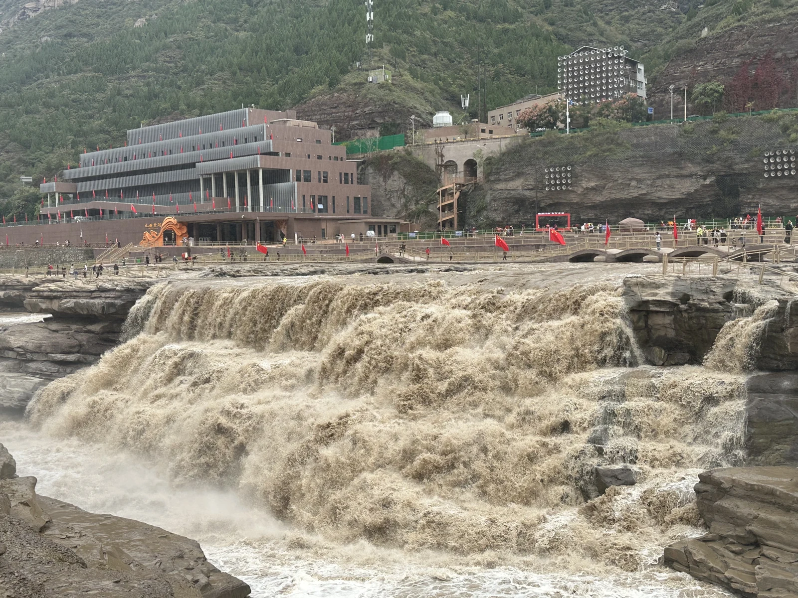 The Hukou falls seen from the Shaanxi bank, with visitor buildings above the gorge