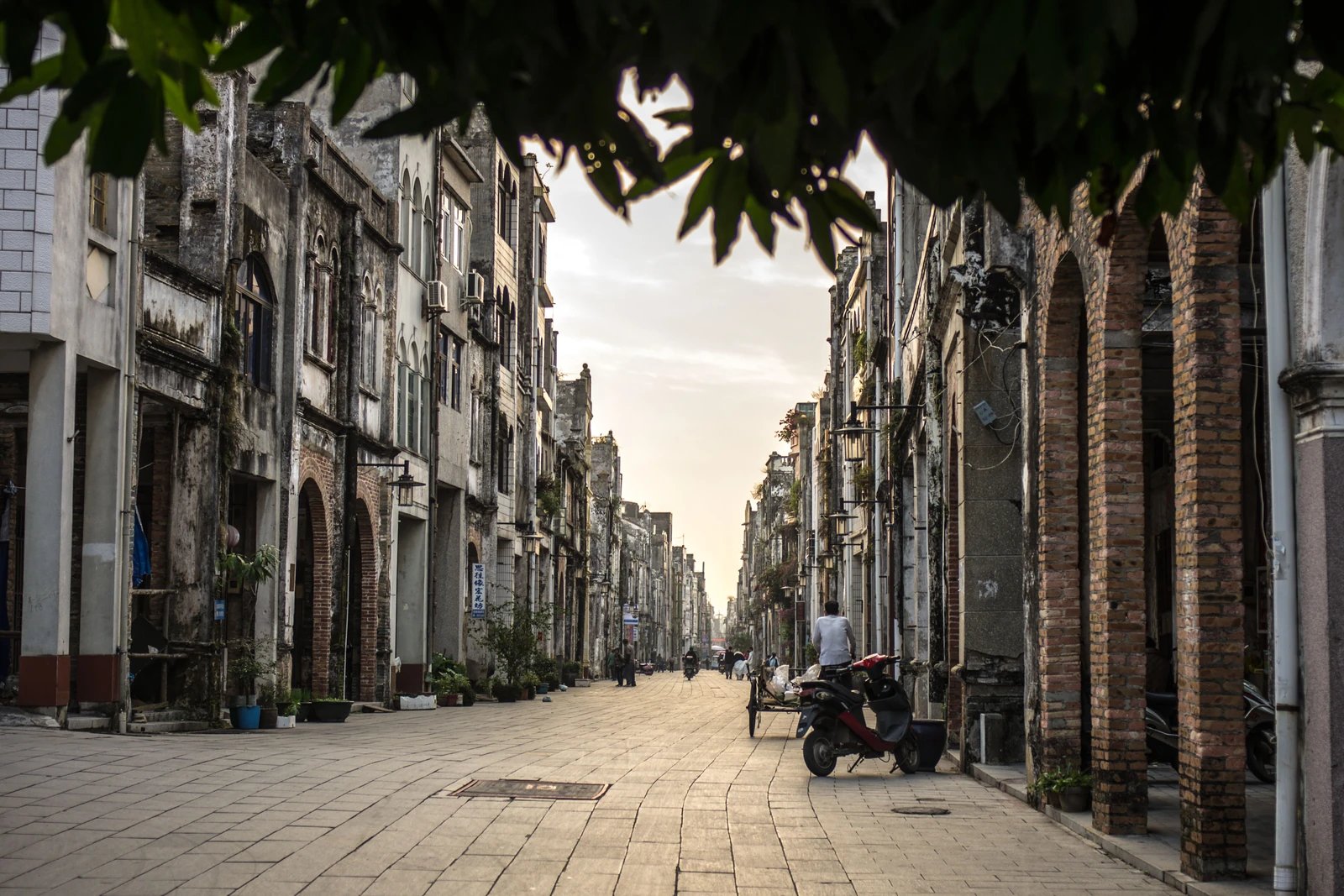 An axial view follows Beihai Old Street between weathered arcaded shopfronts.