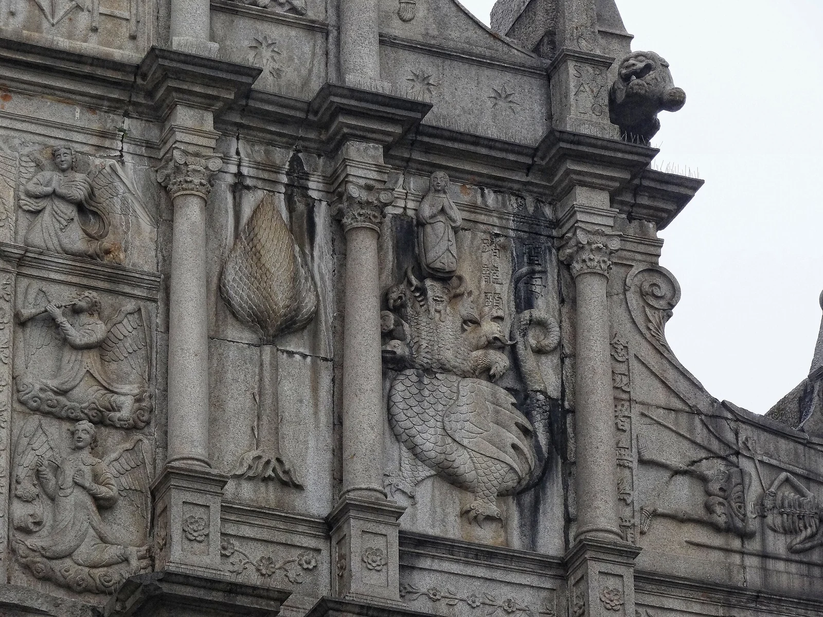 Carved figures and Chinese lettering on the St Paul’s façade.
