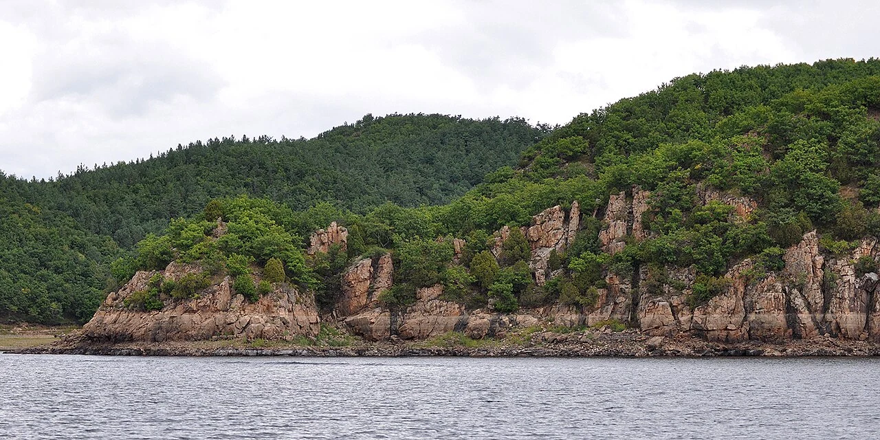 Wooded cliffs along Jingpo Lake