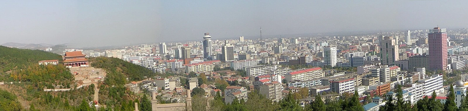Jingmen: a wide panorama of the city spread along the hills.