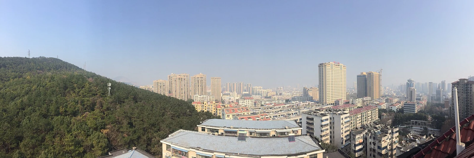 Jingmen: the West City District, with its wooded hill and a white domed hall.