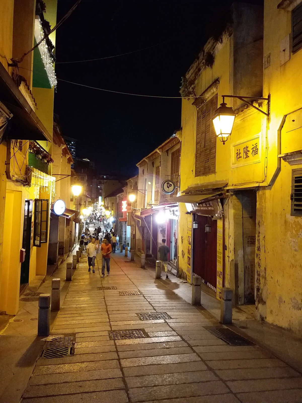 نوافذ حمراء ومداخل وواجهات متاجر في Rua da Felicidade.
