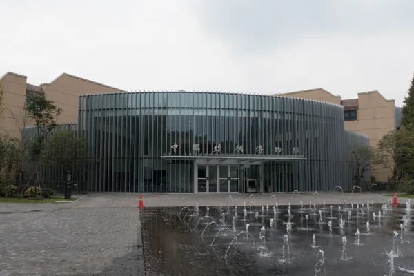 The entrance of China National Silk Museum stands behind a fountain, with its Chinese name above the doors.